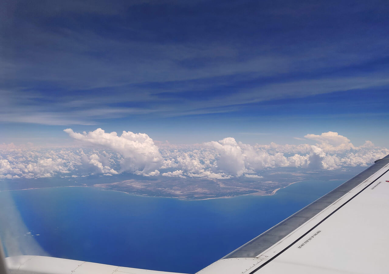 The island of Madagascar appears near the horizon, after crossing the Indian Ocean